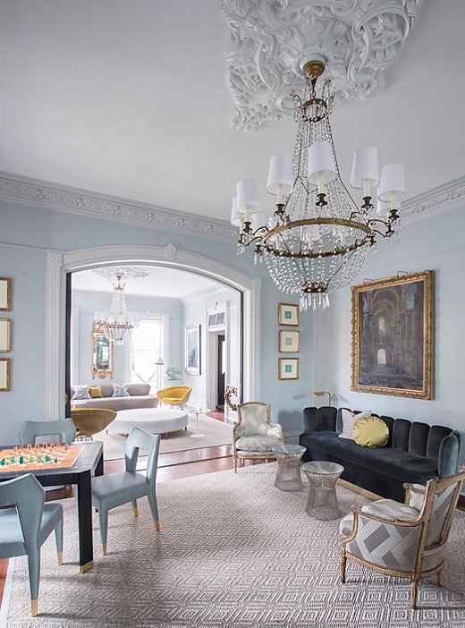 The music room incorporates an inherited piano as well as Johno’s extensive guitar collection, an amp, and conga drums. The Empire chandelier, framed intaglios, and French painting, all from the 19th century, anchor the space in tradition, brightened by a 1960s Charles Hollis Jones Lucite chess set, Warren Platner for Knoll wire side tables, and game-table chairs by L.A. designer Natasha Baradaran.
